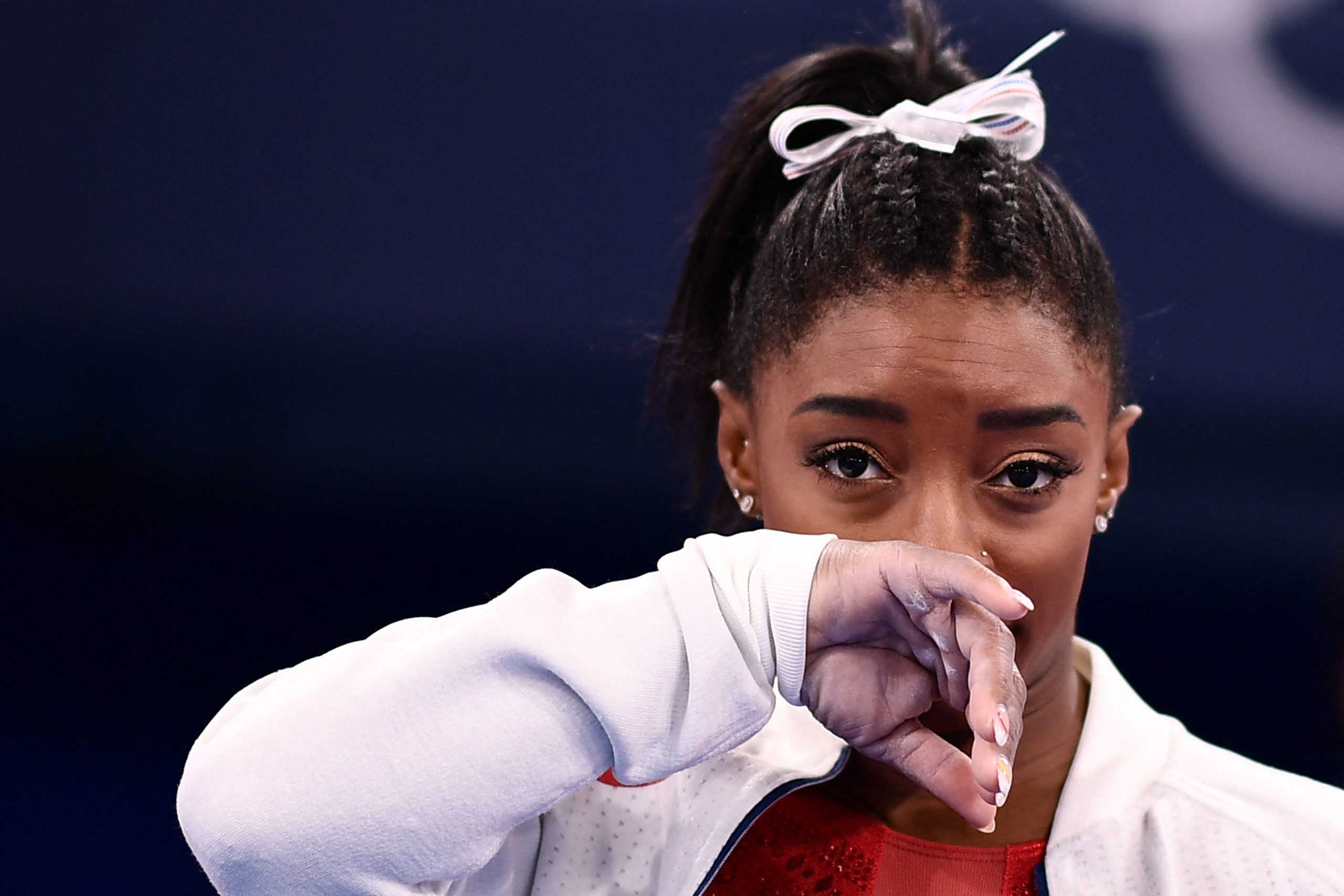 TOPSHOT - USA's Simone Biles gestures during the artistic gymnastics women's team final during the Tokyo 2020 Olympic Games at the Ariake Gymnastics Centre in Tokyo on July 27, 2021. (Photo by Loic VENANCE / AFP) (Photo by LOIC VENANCE/AFP via Getty Images)
