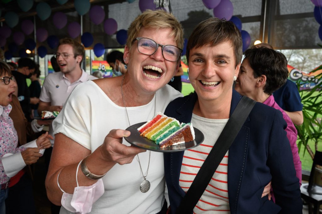 A couple poses with a wedding cake's slice during an event following a nationwide referendum on same-sex marriage, in Swiss capital Bern on September 26, 2021. - Swiss voters have approved the government's plan to introduce same-sex marriage, according to the first projections following September 26 referendum triggered by opponents of the move. Shortly after the polls closed at noon market researchers GFS Bern, who conducted the main polling throughout the campaign, projected that the "yes" vote was heading for victory, which would bring the Alpine nation into line with most of western Europe. (Photo by Fabrice COFFRINI / AFP) (Photo by FABRICE COFFRINI/AFP via Getty Images)