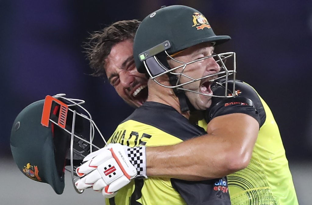 Australia's Marcus Stoinis, holding helmet, and Matthew Wade celebrate after winning the Cricket Twenty20 World Cup semi-final match between Pakistan and Australia in Dubai, UAE, Thursday, Nov. 11, 2021. (AP Photo/Kamran Jebreili)