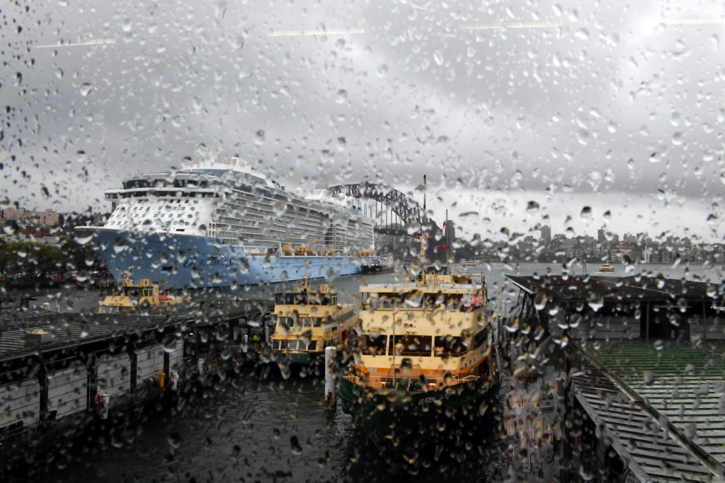 TOPSHOT - Rain droplets are seen on the window of the Circular Quay train station as clouds cover the Sydney Harbour on November 28, 2018. - Flights were cancelled, railway lines closed and motorists stranded on flooded roads as a month's worth of rain fell on Sydney early on November 28, leaving emergency services battling to respond. (Photo by Saeed KHAN / AFP)        (Photo credit should read SAEED KHAN/AFP via Getty Images)
