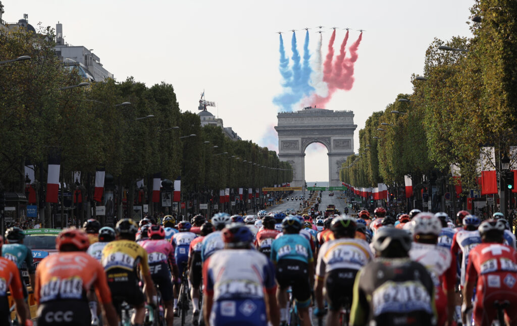 TOPSHOT - French air force's aerobatics demonstration unit "Patrouille de France" (PAF) performs as the pack rides on the Champs Elysees avenue with the Arc de Triomphe in the background during the 21st and last stage of the 107th edition of the Tour de France cycling race, 122 km between Mantes-la-Jolie and Champs Elysees Paris, on September 20, 2020. (Photo by KENZO TRIBOUILLARD / AFP) (Photo by KENZO TRIBOUILLARD/AFP via Getty Images)