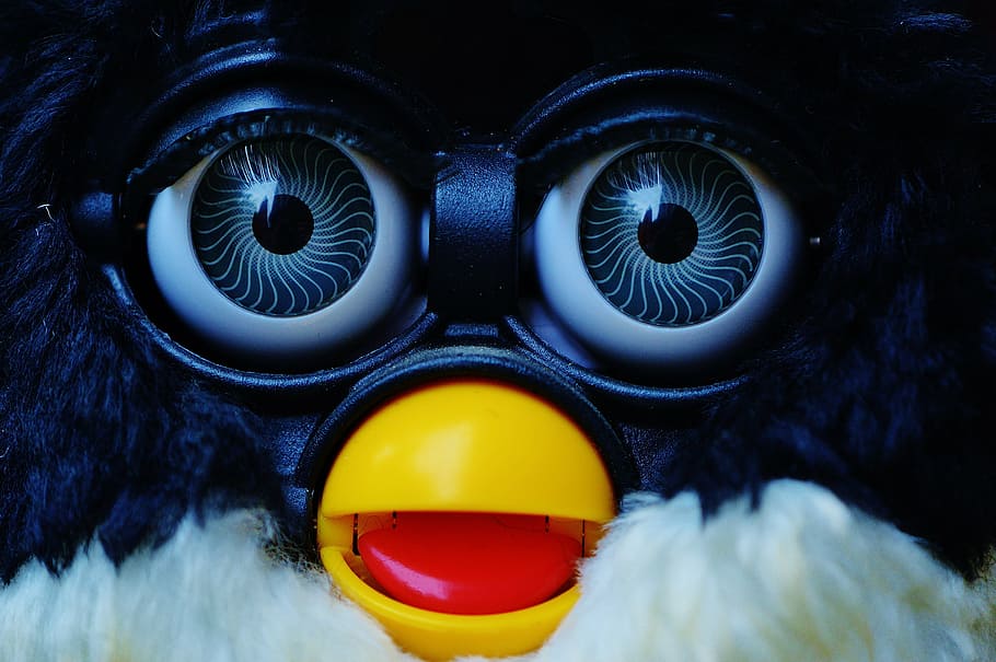 Close-up of a Furby with blue eyes and mouth open