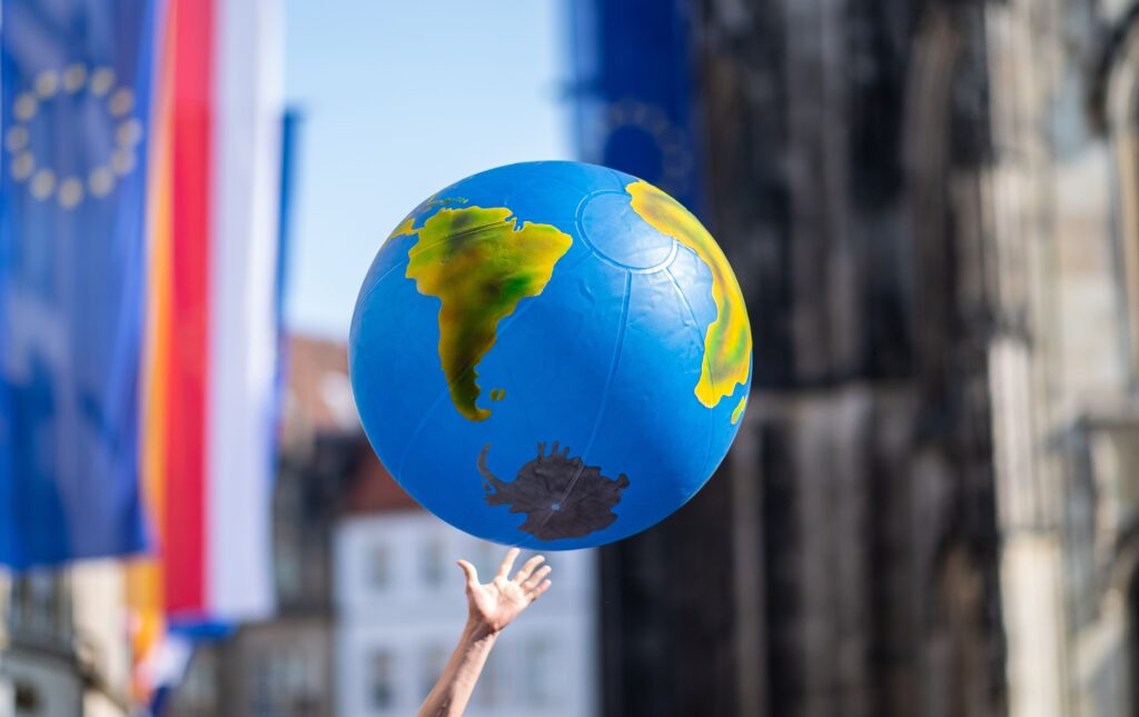TOPSHOT - A student reaches for an inflated globe during a "Fridays for Future" protest for urgent climate action on May 24, 2019 in Muenster, northwestern Germany. - In a shift since the last European Parliament elections, mainstream parties have adopted climate change as a rallying cry -- spurred in part by a wave of student strikes. A Eurobarometer poll shows climate change is now a leading concern for European Union voters, not far behind economic issues and rivalling worries about migration. (Photo by Guido Kirchner / dpa / AFP) / Germany OUT (Photo by GUIDO KIRCHNER/dpa/AFP via Getty Images)